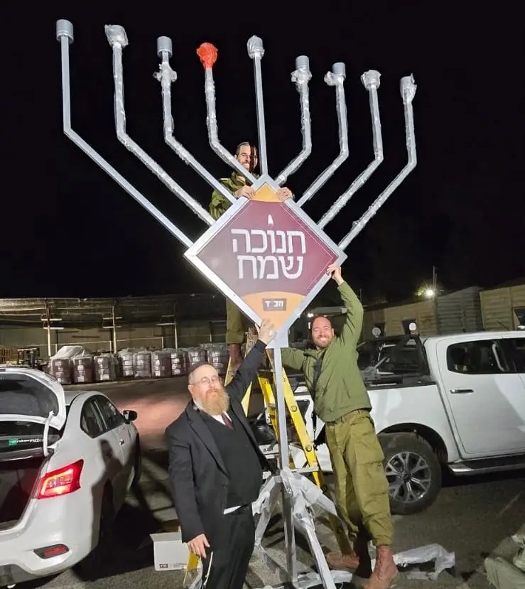 Pictured- Rabbi Hertzel preparing a menorah for soldiers to bring to their post in Syria
